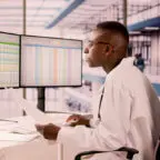 Billing professional demonstrates how to use AI in medical coding on computer